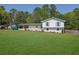 Charming white brick home with well-manicured lawn and covered carport at 3935 Manor House Dr, Marietta, GA 30062