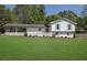 Charming white brick home with well-manicured lawn and covered carport at 3935 Manor House Dr, Marietta, GA 30062