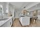 Bright kitchen showcasing white cabinetry, stainless appliances, an island, and an adjacent dining area at 3935 Manor House Dr, Marietta, GA 30062