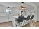 Bright kitchen with a central island, stainless steel appliances, white cabinets, and modern pendant lights at 3935 Manor House Dr, Marietta, GA 30062