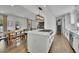 Open kitchen featuring a center island, white cabinets, stainless steel appliances, and modern lighting at 3935 Manor House Dr, Marietta, GA 30062