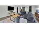Spacious living room features a large sofa, modern entertainment center, and stylish rug at 3935 Manor House Dr, Marietta, GA 30062