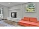 Cozy living room with white brick fireplace and a bright window for natural light at 3935 Manor House Dr, Marietta, GA 30062