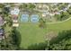 Aerial view of community amenities including a pool, tennis courts, playground, and garden at 1315 Chattahoochee Run Dr, Suwanee, GA 30024