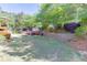 Well-maintained backyard featuring a lush lawn and landscaped garden with stone wall at 1315 Chattahoochee Run Dr, Suwanee, GA 30024