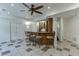 Finished basement features tile floors, a ceiling fan, and a full wet bar at 1315 Chattahoochee Run Dr, Suwanee, GA 30024