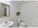 Bright bathroom showcasing a pedestal sink, framed mirror, and shower/tub combination at 1315 Chattahoochee Run Dr, Suwanee, GA 30024