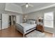 Cozy bedroom with hardwood floors, ceiling fan, and access to laundry room at 1315 Chattahoochee Run Dr, Suwanee, GA 30024