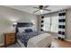 Bedroom with ceiling fan, wood floors and large window at 1315 Chattahoochee Run Dr, Suwanee, GA 30024