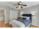 Bedroom with wood floors, ceiling fan and ensuite bathroom at 1315 Chattahoochee Run Dr, Suwanee, GA 30024