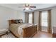 Bedroom featuring wood floors, neutral colored walls, and two windows with blinds at 1315 Chattahoochee Run Dr, Suwanee, GA 30024