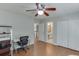 Bedroom with wood floors, ceiling fan, desk and view into bathroom at 1315 Chattahoochee Run Dr, Suwanee, GA 30024