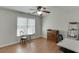 Bedroom with ceiling fan, wood floors and large window at 1315 Chattahoochee Run Dr, Suwanee, GA 30024