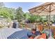 Outdoor deck with gray wood, orange and blue furniture and grill at 1315 Chattahoochee Run Dr, Suwanee, GA 30024