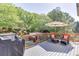Outdoor deck with gray wood, umbrella, and orange furniture at 1315 Chattahoochee Run Dr, Suwanee, GA 30024