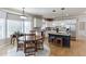Well-appointed kitchen with a dining area, white cabinets, and a central island with bar seating, great for Gathering dinners at 1315 Chattahoochee Run Dr, Suwanee, GA 30024