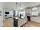 Spacious kitchen with a central island, white cabinets, and modern appliances, perfect for cooking at 1315 Chattahoochee Run Dr, Suwanee, GA 30024