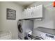 Laundry room with deluxe laundry service signage, washer and dryer at 1315 Chattahoochee Run Dr, Suwanee, GA 30024