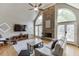 Living room boasting high ceilings, large windows, stone fireplace and neutral walls at 1315 Chattahoochee Run Dr, Suwanee, GA 30024
