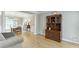 Open-concept living room with hardwood floors, traditional furniture, and a view into the dining area at 1315 Chattahoochee Run Dr, Suwanee, GA 30024