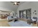 Open-concept living room with gray sofa, wooden coffee table, and view into kitchen at 1315 Chattahoochee Run Dr, Suwanee, GA 30024