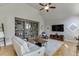 Living room featuring a vaulted ceiling, a large TV, gray bookshelves, and neutral decor at 1315 Chattahoochee Run Dr, Suwanee, GA 30024