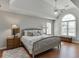 Main bedroom with tray ceiling, ceiling fan and large window at 1315 Chattahoochee Run Dr, Suwanee, GA 30024