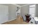 Comfortable office featuring neutral walls, hardwood floors, and a view of the staircase and front entryway at 1315 Chattahoochee Run Dr, Suwanee, GA 30024