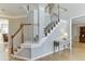 Elegant staircase with white railings, hardwood steps, and views into the home's interior at 1315 Chattahoochee Run Dr, Suwanee, GA 30024