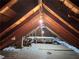Large attic featuring wooden beams and floorboards, offering ample space for storage or potential conversion at 1900 Ridgewood Ne Dr, Atlanta, GA 30307