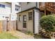 Exterior showing a sunroom and backyard area with gravel, grass, and a wooden fence at 1900 Ridgewood Ne Dr, Atlanta, GA 30307