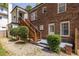 Exterior view showcasing a brick house with a wooden staircase and a well-maintained yard at 1900 Ridgewood Ne Dr, Atlanta, GA 30307