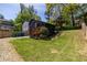 Spacious backyard featuring lush greenery and ample space for outdoor activities, complemented by a charming black home exterior at 1900 Ridgewood Ne Dr, Atlanta, GA 30307