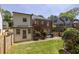 Backyard with a grassy lawn, mature trees, and a charming staircase leading to an upper level at 1900 Ridgewood Ne Dr, Atlanta, GA 30307