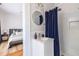 Bright bathroom featuring a white vanity, subway tile shower, and charming round mirror at 1900 Ridgewood Ne Dr, Atlanta, GA 30307