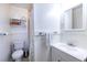 Cozy bathroom featuring a toilet, vanity sink, and ample storage shelves, providing a functional and organized space at 1900 Ridgewood Ne Dr, Atlanta, GA 30307