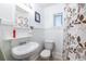 Clean bathroom featuring a sink, mirror, toilet, and patterned shower curtain at 1900 Ridgewood Ne Dr, Atlanta, GA 30307