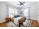 Comfortable bedroom features a ceiling fan, wood floors, lots of natural light, and decorative rug with neutral colors at 1900 Ridgewood Ne Dr, Atlanta, GA 30307
