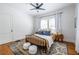 Well-lit bedroom features wood floors, a ceiling fan, lots of natural light and neutral colors for a cozy retreat at 1900 Ridgewood Ne Dr, Atlanta, GA 30307