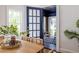Dining room with hardwood floors, modern table and chairs, and a view into the sunroom at 1900 Ridgewood Ne Dr, Atlanta, GA 30307
