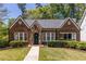Charming brick home with stone accents and a well-manicured lawn at 1900 Ridgewood Ne Dr, Atlanta, GA 30307