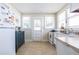 Bright kitchen with natural light, including appliances, white cabinets, and tiled floor, offering a clean and functional cooking space at 1900 Ridgewood Ne Dr, Atlanta, GA 30307