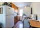 Functional kitchen featuring wooden cabinets, white appliances, and natural light from the window at 1900 Ridgewood Ne Dr, Atlanta, GA 30307