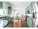 Bright kitchen with green cabinetry, stainless steel appliances, dark counters, and breakfast nook at 1900 Ridgewood Ne Dr, Atlanta, GA 30307