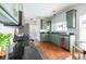 Stylish kitchen boasts green cabinetry, stainless steel appliances, and dark countertops at 1900 Ridgewood Ne Dr, Atlanta, GA 30307
