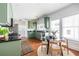 Charming kitchen features green cabinetry, black countertops, stainless appliances, and adjacent breakfast nook at 1900 Ridgewood Ne Dr, Atlanta, GA 30307