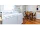 Convenient laundry area combined with dining space, featuring modern appliances and wooden floors, providing functionality and style at 1900 Ridgewood Ne Dr, Atlanta, GA 30307