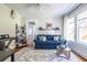 Bright living room with a cozy blue sofa, patterned rug, and plenty of natural light at 1900 Ridgewood Ne Dr, Atlanta, GA 30307