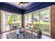 Cozy sunroom featuring brick walls, blue ceiling, and comfortable seating with natural light at 1900 Ridgewood Ne Dr, Atlanta, GA 30307
