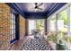 Bright sunroom with a blue ceiling, brick accent wall, and comfortable bench seating at 1900 Ridgewood Ne Dr, Atlanta, GA 30307